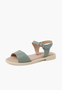 Green leather sandal with two wide foot straps, open toe, and an adjustable ankle strap. Light tan cushioned footbed and rubber sole.