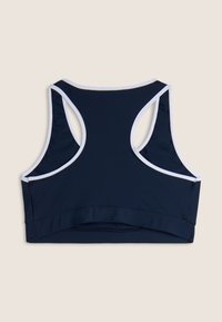Reggiseno sportivo blu navy con accenti bianchi, design a schiena scoperta, texture liscia e banda elastica nella parte inferiore per una vestibilità sicura.