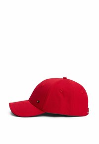 Red cotton baseball cap with a curved brim, stitched eyelets, and a logo on the front. Adjustable strap at the back for sizing.