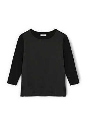 Haut noir à manches longues avec col rond, manches ajustées et ourlet droit, posé à plat sur un fond blanc.