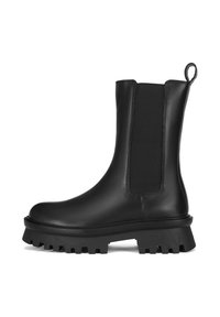 Czarny skórzany botek za kostkę z elastycznymi panelami boków, wytrzymałą gumową podeszwą i pętelką z tyłu. Charakteryzuje się smukłą sylwetką i matowym wykończeniem.