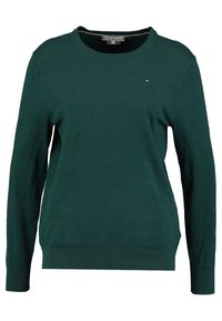 Vihreä neulottu neulepaita, jossa pitkät hihat, pyöreä pääntie ja resorit hihansuissa. Vasemmassa rinnassa pieni logo. Sileä pinta.