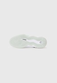 Shoe sole featuring a green, textured rubber surface with swirling patterns. White accents along the edge and a circular cut-out detail.