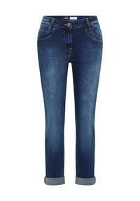 Jeans de mezclilla azul oscuro con puños enrollados, botón frontal y cremallera, dos bolsillos frontales y una etiqueta con la inscripción "Cecil" en la cinturilla.