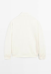 Vue arrière d'une veste à manches longues de couleur crème, avec un col, des poignets et un ourlet côtelés, fabriquée à partir d'un matériau doux et présentant un design simple.