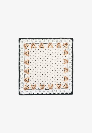 Pañuelo cuadrado con lunares sobre un fondo crema. Presenta un borde de encaje festoneado y dibujos de perros con pajaritas a lo largo de los bordes.