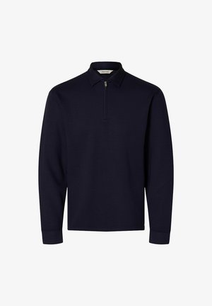 Tamsiai mėlynas ilgomis rankovėmis megztinis su trumpu priekinio užtrauktuku ir smailiomis apykaklėmis, pagamintas iš lygaus, vientiso audinio.