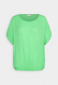 Blouse ample vert vif avec manches dolman courtes, encolure ronde et ourlet élastiqué.