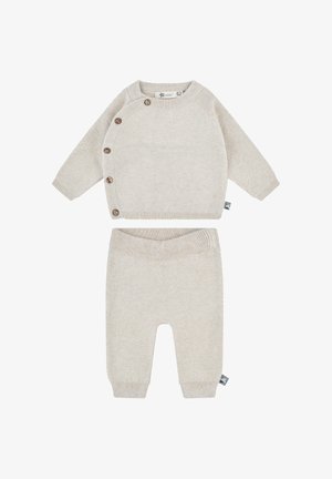 Knitted beige sweater with side buttons and a textured pattern, paired with matching beige pants featuring a ribbed waistband.