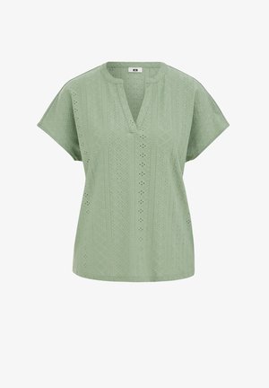 Šviesiai žalia trumpomis rankovėmis palaidinė su V formos iškirpte ir akių nėrinių raštu, kuriame yra geometrinių ir gėlių iškirpimų dizainai.