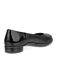 Black leather ballet flat with a rounded toe. Includes a textured black heel and smooth upper section. No visible embellishments or patterns.