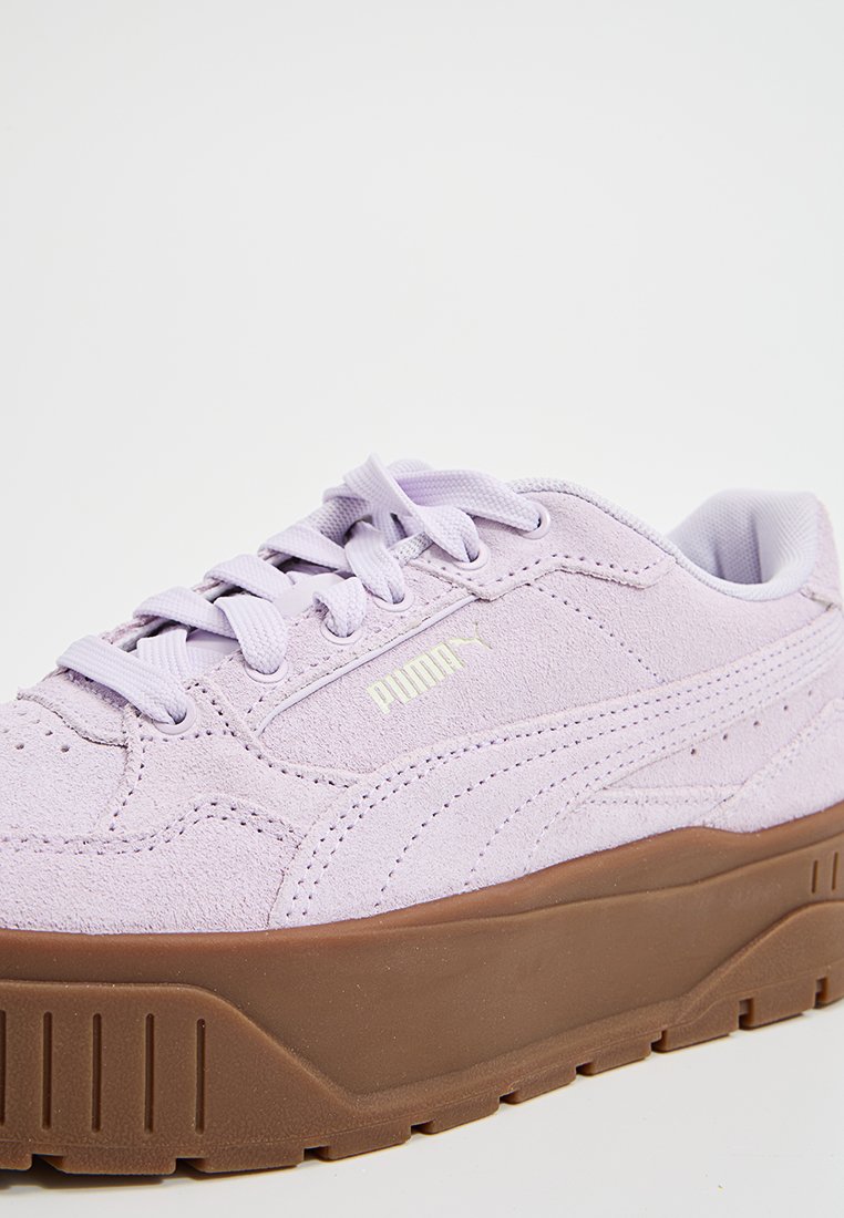Sneakers en suedine lilas avec une épaisse semelle plateforme marron, bout rond et lacets plats. Présente un logo en relief sur le côté.