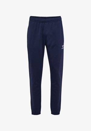 Pantaloni della tuta blu navy con vita elasticizzata e polsini alla caviglia, con un piccolo logo bianco Hummel sulla parte superiore della coscia sinistra.