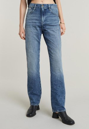 Light blue denim jeans with a high waist and straight leg, featuring a faded wash, five pockets, and a button closure.