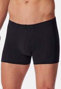 Schwarze Baumwollboxershorts mit figurnaher Passform, elastischem Bund und glatter Textur, versehen mit einem konturierten Pouch für Unterstützung.