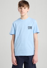 Light blue cotton t-shirt with crew neck, short sleeves, and a black "GOOD LIFE" graphic on the left chest area.