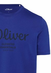 Blue cotton t-shirt with short sleeves, featuring a large black printed logo and text "s.Oliver ELEVATED ESSENTIALS SINCE 1969."