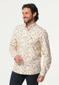Heren overhemd met knopen, versierd met een geel bloemenpatroon, gemaakt van lichtgewicht stof, met lange mouwen en een standaard kraagontwerp.