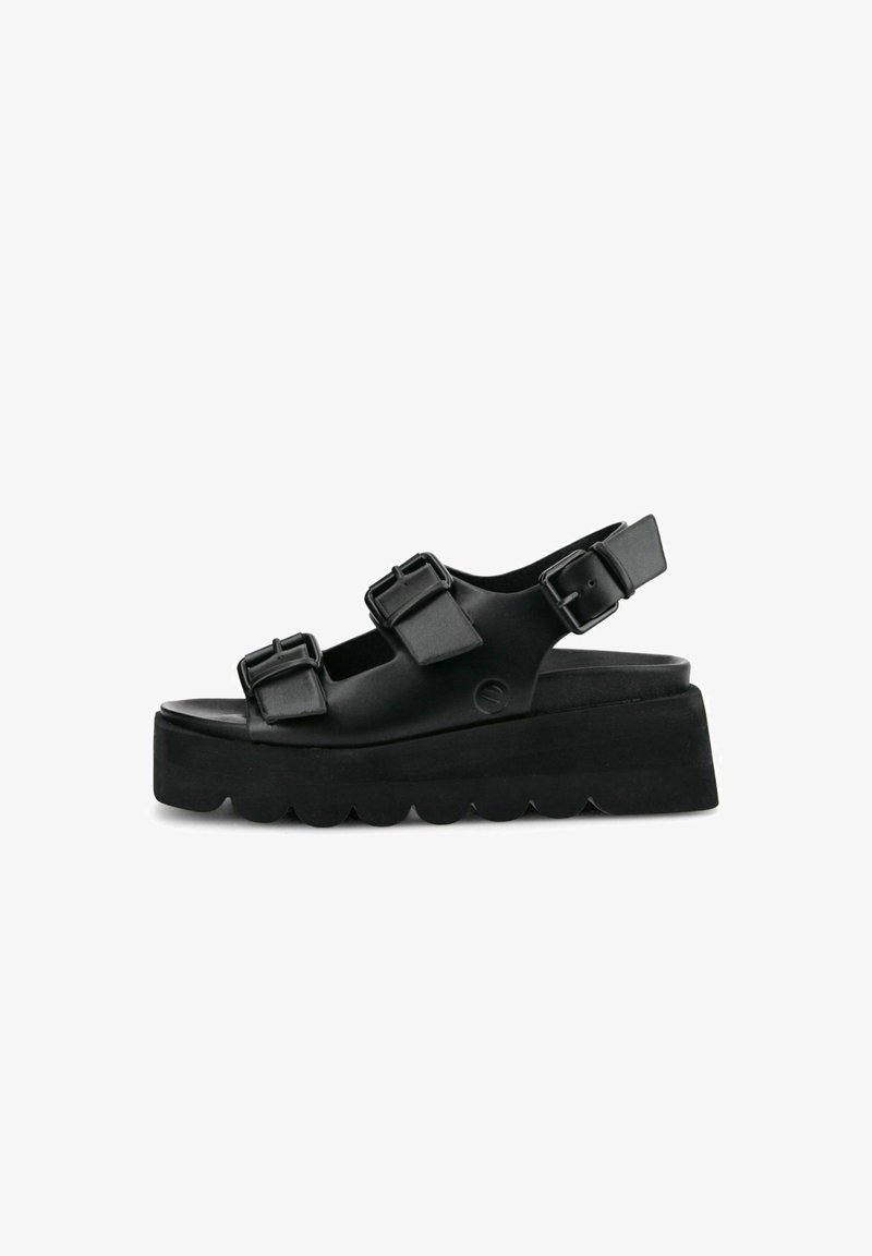 Black platform sandals made of synthetic material, featuring three adjustable buckle straps and a wavy sole design.