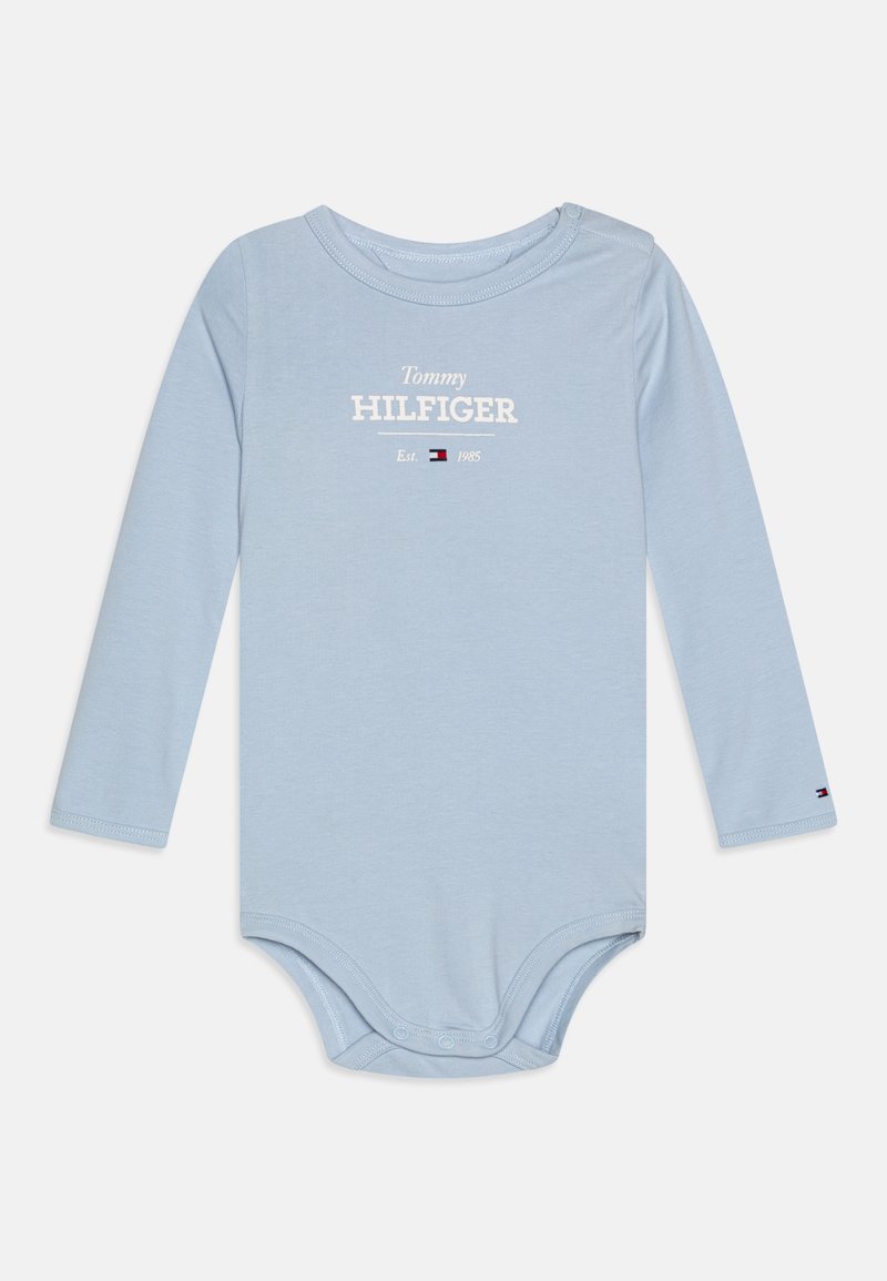 Light blue long-sleeve bodysuit made of soft cotton, featuring "Tommy HILFIGER" text in white and a logo at the bottom. Snap closure at the bottom.