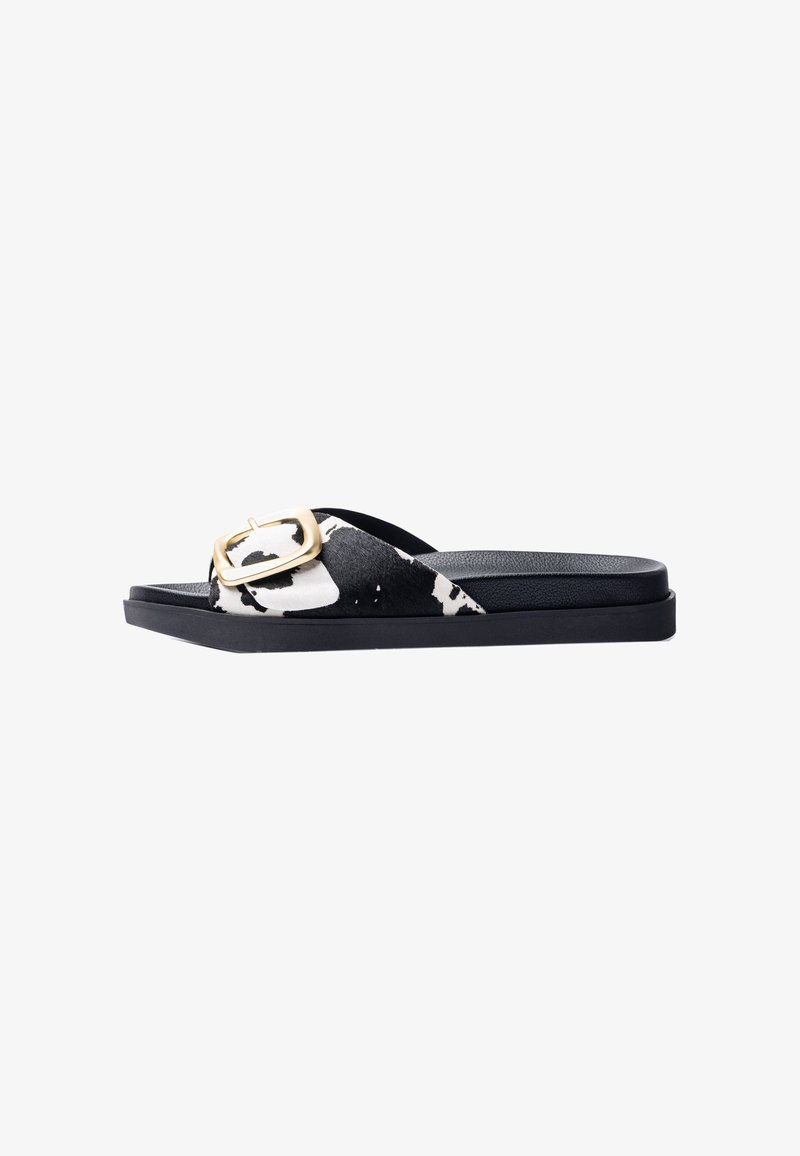 Black and white slide sandals with a textured fabric upper featuring a gold rectangular buckle and a flat black rubber sole.