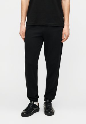 TRAIN LOGO SERIES MAN PANTS TAPE - Spodnji deli trenirk - black