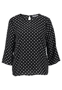 Svart blus med vita prickar, rund halslinning med nyckelhålsknäppning och trekvarts flare ärmar.