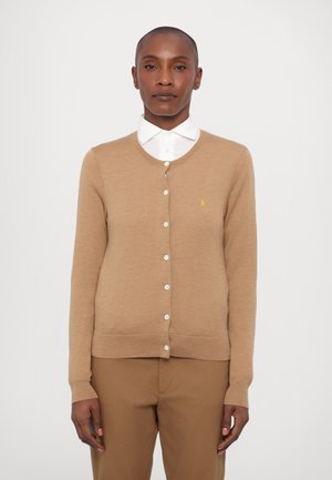 Light brown cardigan sweater with a round neckline, button closure, and a small yellow logo on the left chest. Long sleeves, ribbed cuffs.