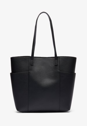 Borsa a tracolla in pelle nera con manici lunghi e due tasche laterali, in piedi su uno sfondo bianco.