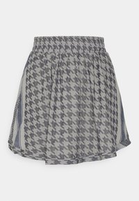 Šedá a námořnická sukně s kostkovaným vzorem houndstooth. Elastický pas a lehká tkanina, s bočními rozparky pro snadný pohyb.