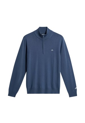 Mörkblå stickad tröja med hög krage och fyrdelad dragkedja. Har ribbade ärmslut och nederkant, samt en liten logotypdetalj på bröstet.