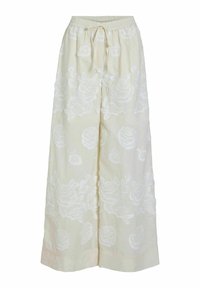 Pantalones de pierna ancha en beige claro, con bordado floral blanco, cintura elástica con cordón y textura suave.