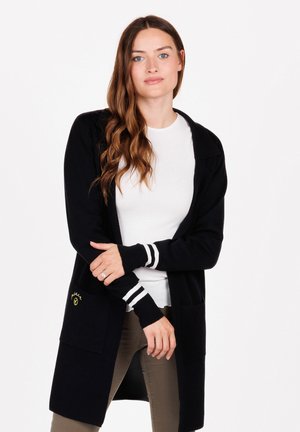 Long black cardigan with stripe accents on sleeves, made of a soft material. Features two front pockets and a small logo near the hem.