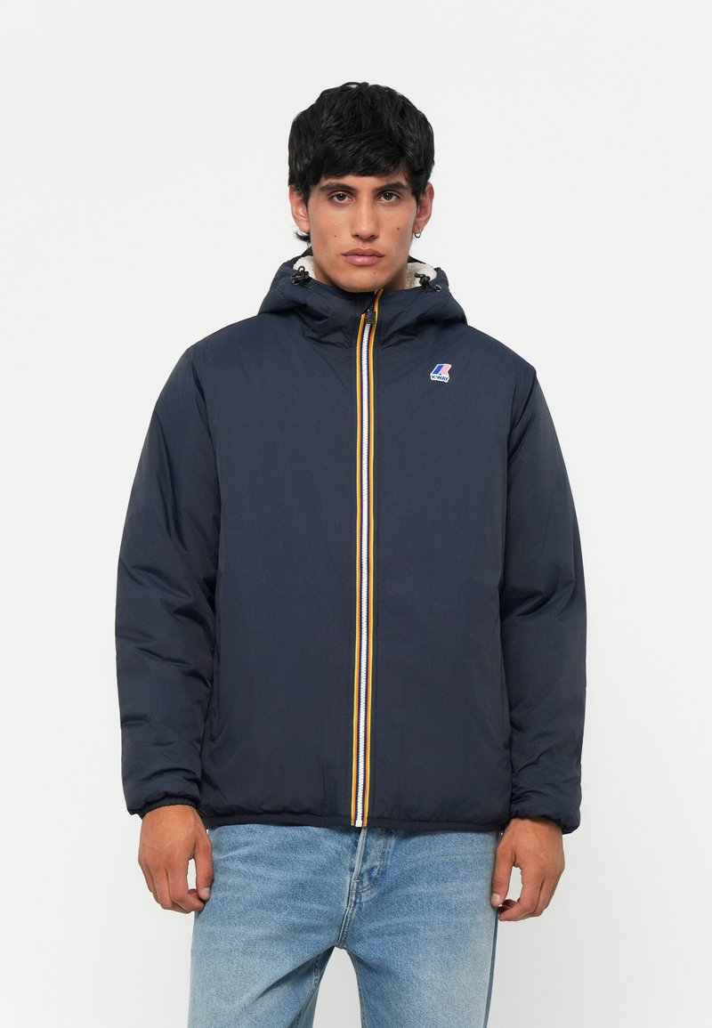 Navy puffer jacket with a hood, featuring a front zipper with yellow and white stripes. Includes a small logo on the left chest.