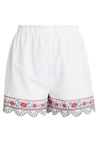 Bílé krátké kalhoty s texturou, elastickým pasem, vroubkovaným lemem a květinovou výšivkou v červené, tyrkysové a černé barvě podél spodního okraje.