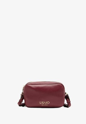 Maroon leather crossbody bag with gold hardware, featuring a zip closure and an adjustable strap. Brand logo displayed on the front.
