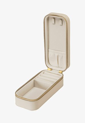 Beige Schmuckkästchen mit einer glatten Außenseite, goldenem Reißverschluss und weichem Innenraum. Verfügt über individuelle Fächer und eine kleine Tasche zur Aufbewahrung.