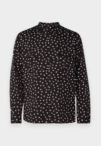 Černá košile na knoflíky s bílým vzorem hvězd, dvěma náprsními kapsami a klasickým límečkem. Dlouhé rukávy s knoflíkovými manžetami.