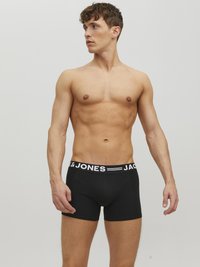 Schwarze Boxershorts aus Baumwolle mit einem weißen elastischen Bund, der die Marke "JACK & JONES" trägt. Enganliegendes Design, bis zur Mitte des Oberschenkels.