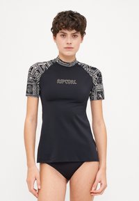 Black rash guard with patterned sleeves, short sleeves and high neckline. Features a Rip Curl logo in gold on the front. Smooth texture.