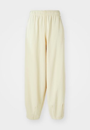 Sweatpants v kremni barvi z elastičnim pasom, zožanimi manšetami in ohlapnim krojem. Izdelani iz mehkega, lahkega materiala.