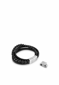 Black leather bracelet featuring braided design and round lava stone beads. Includes a silver-tone metal clasp and a removable connector.