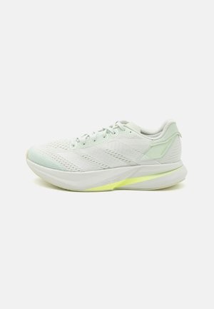 Chaussures de course légères en mesh blanc avec des accents vert menthe. Elles disposent d'une semelle intermédiaire amortissante et d'un dessus texturé pour une meilleure respirabilité.