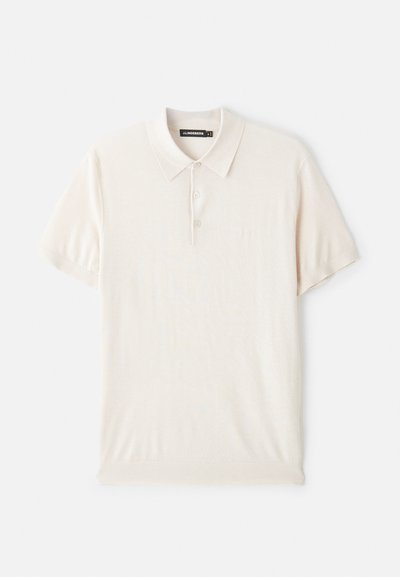 Gai krēmkrāsas polo krekls ar klasisku apkakli, trīs pogu aizdari un īsām piedurknēm. Izgatavots no mīksta, gluda auduma. Vienkāršs dizains bez rakstiem.
