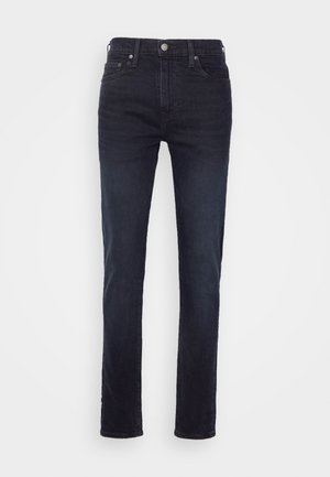 Dunkelblaue Denim-Jeans mit geradem Schnitt, fünf Taschen, einem Frontknopfverschluss und leichtem Fading an den Oberschenkeln.