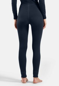 Navy thermal leggings with a ribbed texture, tapered fit, and elastic waistband. Ankle cuffs offer a snug finish.