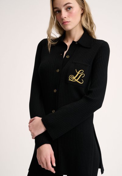 Black ribbed cardigan made of knit material with long sleeves, gold buttons, and a gold embroidered "L" on the left pocket.