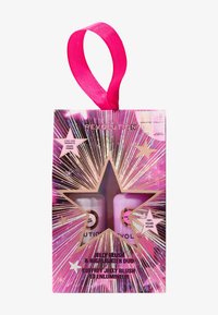 Roze verpakking met een sterontwerp, met twee doorzichtige flessen met jelly blush en highlighter. Inclusief een roze linthandvat.