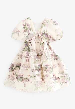Virágmintás ruha világos krémszínű anyagból, pöttyös ujjakkal és hátul megkötővel. Rózsaszín és zöld árnyalatú virágmintás rétegekkel díszített.
