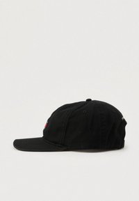 Gorra negra con visera curva, con un logotipo en la parte frontal en rojo, azul y blanco. Hecha de una tela texturizada con orificios de ventilación.